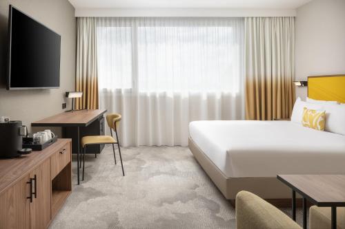 a hotel room with a bed and a television at Hyatt Place Paris Charles de Gaulle Airport in Roissy-en-France