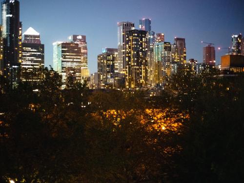 a view of a city skyline at night at Charming and Cosy Canary Wharf Room with Stunning Views in London