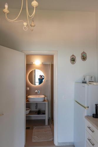 a bathroom with a sink and a mirror at Anna Apartments Boukari in Boukari