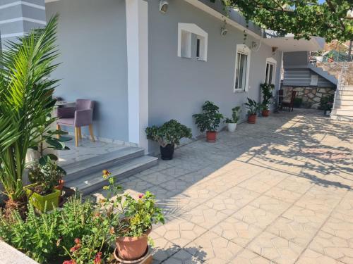 a patio with potted plants on the side of a house at VIla Markel in Sarandë