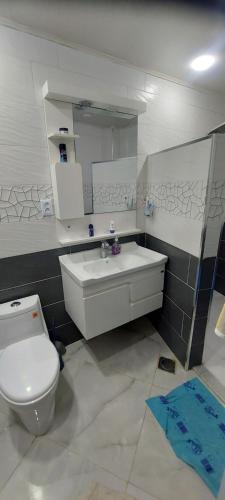 a bathroom with a white toilet and a sink at Maison de vacances vue sur la mer in Mazer