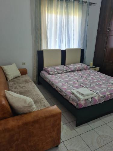a bedroom with a bed and a couch at VIla Markel in Sarandë