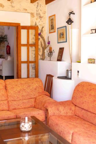a living room with a couch and a table at Can Olivera in Llubí