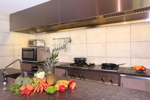 a kitchen with a bunch of fruits and vegetables on a counter at 't Borghuis in Losser