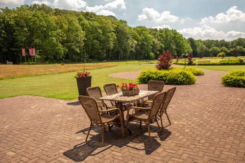a table and chairs sitting on a brick patio at 't Borghuis in Losser