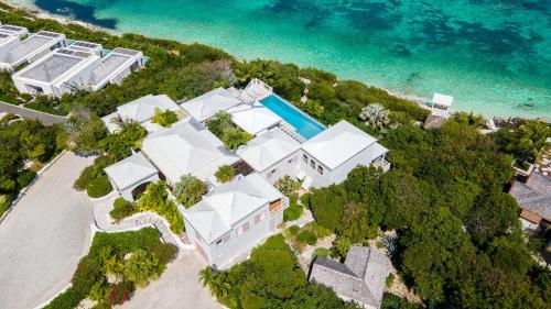 an aerial view of a white building on the beach at Reef Tides Luxury Beach House in Providenciales