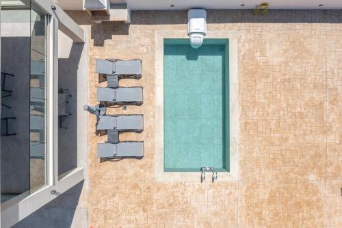 a building with a swimming pool and a window at Villa Katerina 1 in Marioú