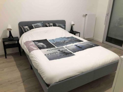a bedroom with a bed with a white blanket on it at Les jardins d'abraxas in Noisy-le-Grand