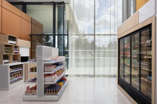 a grocery store aisle with a large glass wall at Hyatt Place Paris Charles de Gaulle Airport in Roissy-en-France