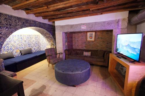 a living room with a couch and a tv at WOT New Lisbon in Lisbon