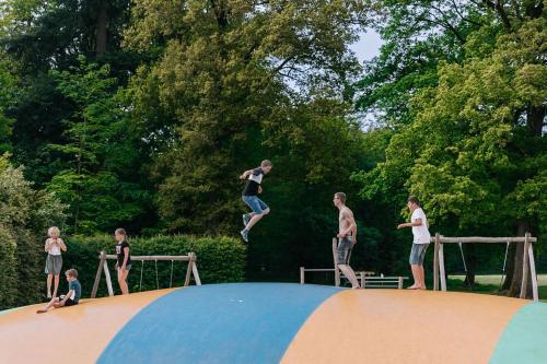 a group of people jumping on top of a trampoline at 't Borghuis in Losser