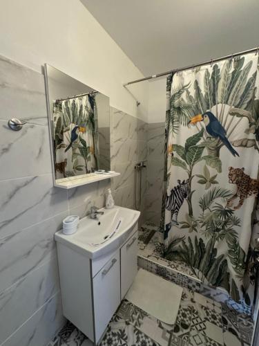 a bathroom with a sink and a shower curtain at Vila Timona in Eforie Nord