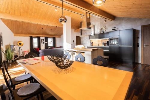 a kitchen with a large wooden table and chairs at N6 Oberstdorf in Oberstdorf