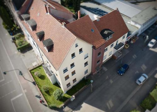 an overhead view of a large white building with a red roof at Beautiful Apartments in Hanau in Hanau am Main