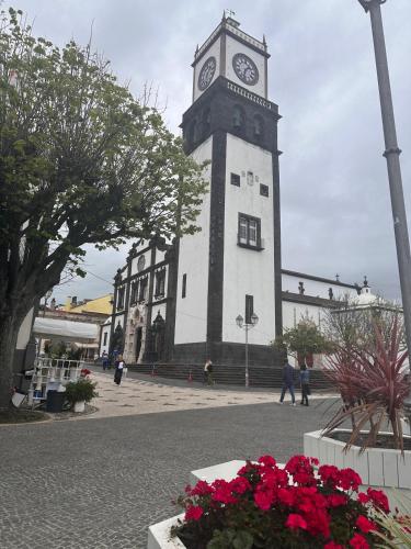 a large clock tower with a clock on it at Azor International Hostel in Ponta Delgada
