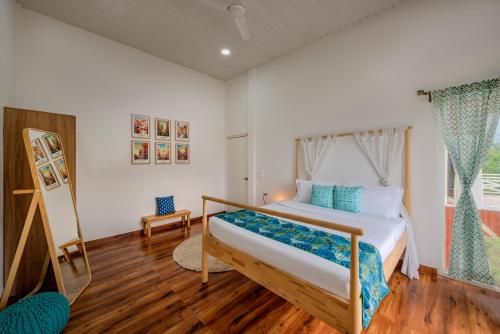 a bedroom with a bed and a window at SaffronStays Aranyaani in Dhamni