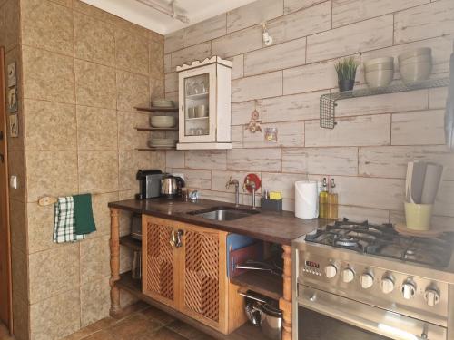 a kitchen with a sink and a stove at House with Private Roof Terrace in Centre in Tavira