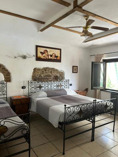 a bedroom with a bed and a ceiling fan at Ca'Silvia in San Savino
