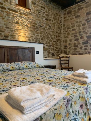 a bedroom with a bed with towels on it at Ca'Silvia in San Savino
