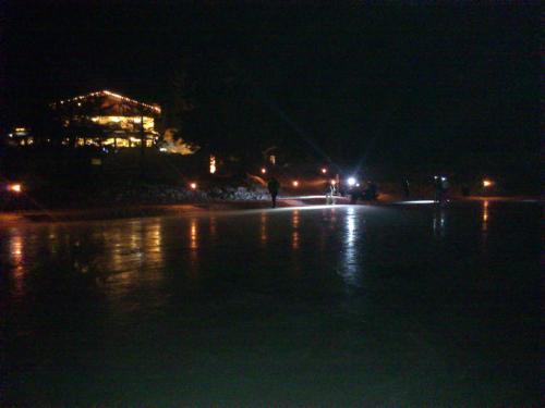 a beach at night with a building in the background at Albergo Chalet Lago Antorno in Misurina