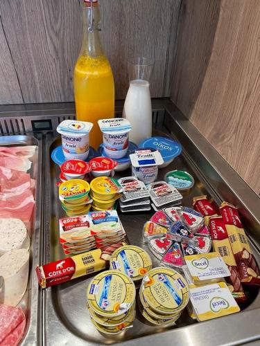 a refrigerator filled with food and a bottle of milk at Chambres tourismes in Pepinster