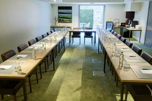 a large room with long tables and chairs at Le Côté Vert in Waterloo