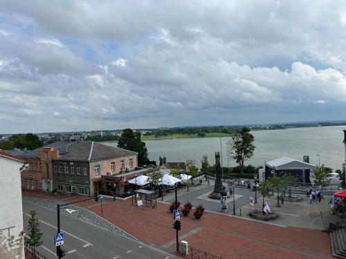 a view of a town with a river and buildings at Telšių centras in Telšiai
