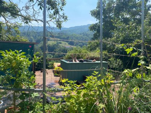 a person laying in a hot tub in a garden at Casa Luna in Monesiglio