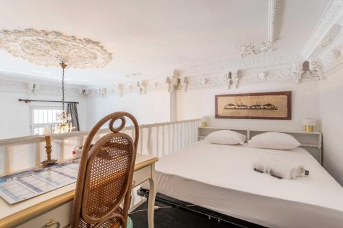 une chambre avec un lit et un bureau avec une chaise dans l'établissement 1 bedroom duplex with AC near the Old Port, à Marseille