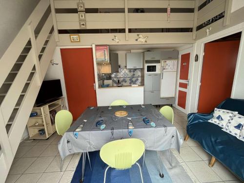 une cuisine avec une table et des chaises dans une pièce dans l'établissement Appartement 2 pièces à St Hilaire-de-Riez avec parking et balcon - FR-1-324-145, à Saint-Hilaire-de-Riez