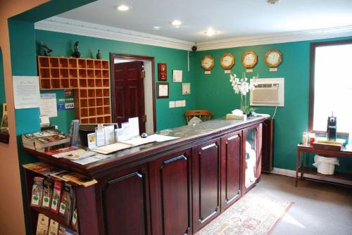 a kitchen with wooden cabinets and a counter top at Commons Inn in Halifax