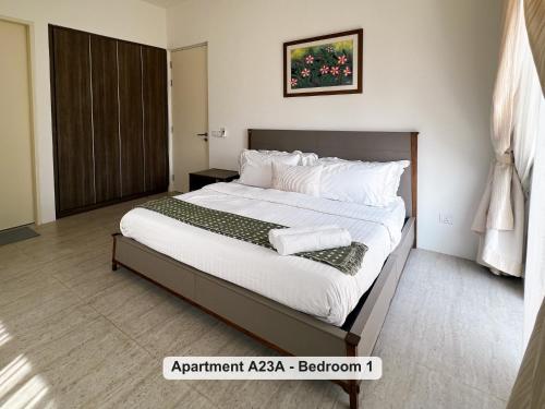 a bedroom with a large bed with white sheets and pillows at By the Sea- Pool and Sea View in Batu Ferringhi