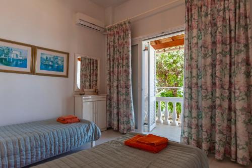 a bedroom with a bed and a large window at Anna Apartments Boukari in Boukari
