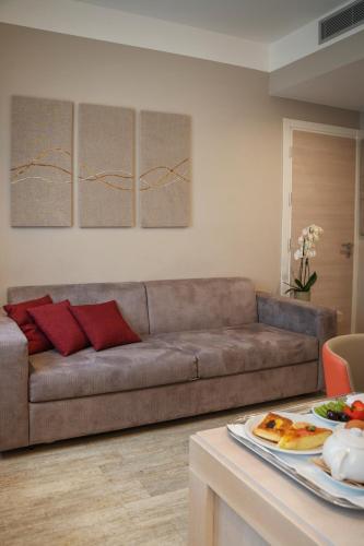 a living room with a brown couch and a table at Hotel Villa Maria Regina in Rome