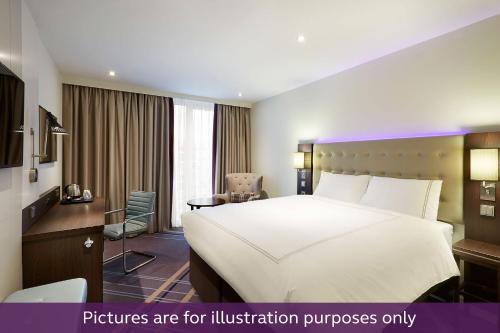 a hotel room with a bed and a desk at Premier Inn Rosenheim City Lokhöfe in Rosenheim