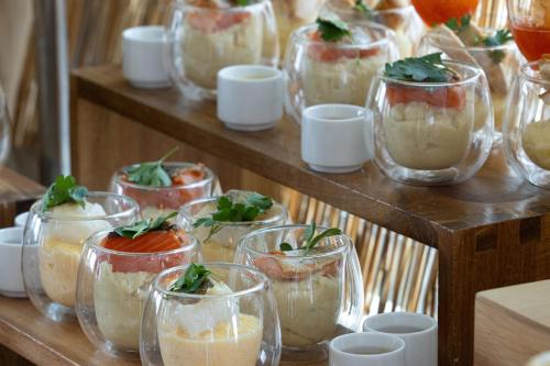 a group of glasses filled with food on a table at Hyatt House Paris Charles de Gaulle Airport in Roissy-en-France
