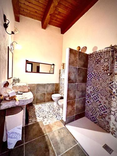 a bathroom with a shower and a toilet in it at Antica Masseria Il Casone in Candela