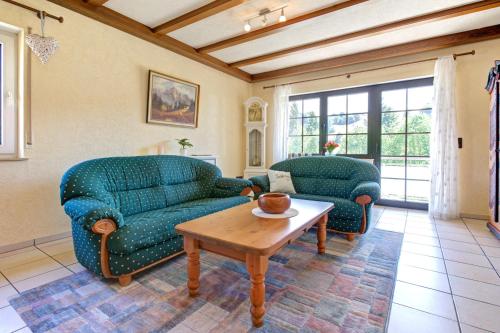 a living room with two couches and a coffee table at Apartment Landhotel Zum Storchennest in Bann