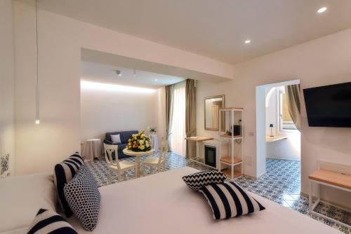 a bedroom with a bed and a living room at Hotel Montemare in Positano