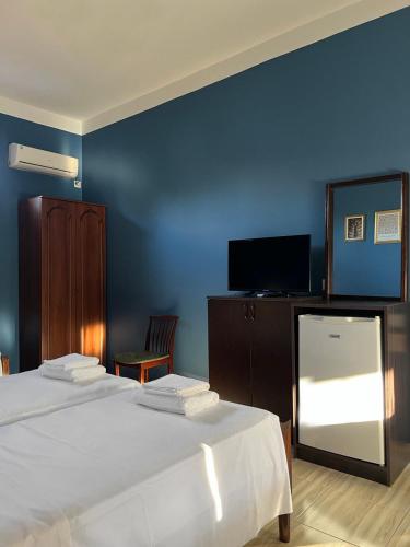 Un ou plusieurs lits dans un hébergement de l'établissement Savane hotel