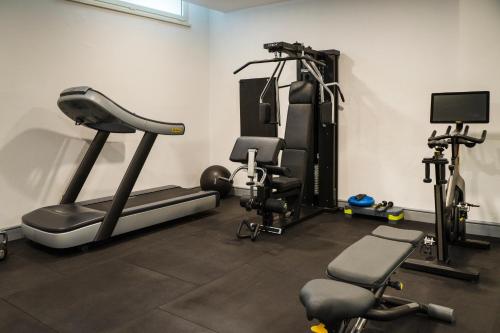 a gym with several exercise equipment in a room at Hotel Villa Maria Regina in Rome