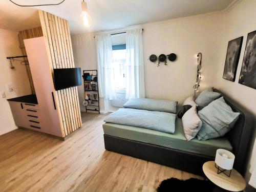 a living room with a couch and a bed at Der schönste Platz in der Altstadt in Amberg