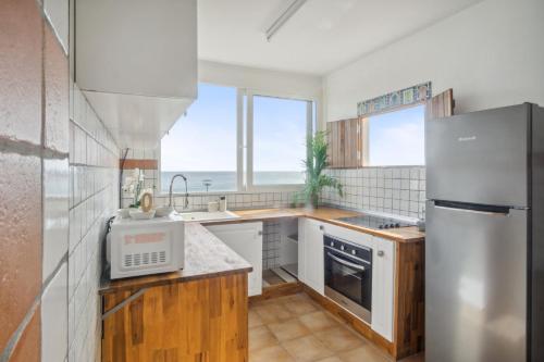 a kitchen with a refrigerator and a sink at Appartement Bourg de Schoelcher - Rooftop in Schœlcher