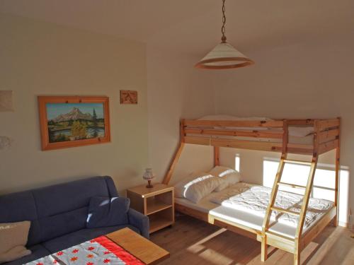 a living room with a bunk bed and a couch at Good Vintage Apartment in Bad Mitterndorf