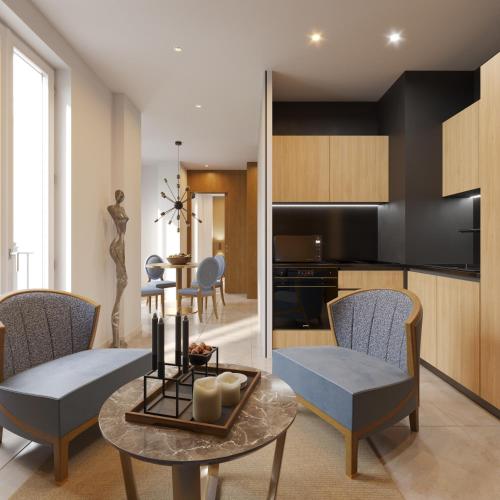 a kitchen and living room with a table and chairs at Résidence Aston la Scala in Nice