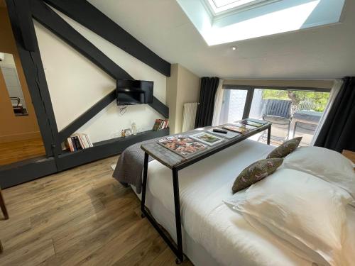 a bedroom with a large bed with a skylight at Le Florida Auberge contemporaine in Castéra-Verduzan