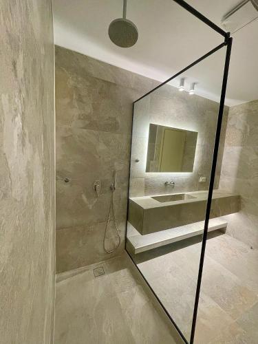 a bathroom with a sink and a mirror at Casa Suites Mykonos in Agios Stefanos