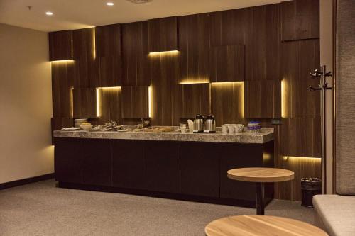a kitchen with a counter with a sink and a stool at Avantgarde Urban Sisli in Istanbul