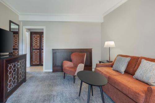 a living room with a couch and a table at Delta Hotels by Marriott St Pierre Country Club in Chepstow