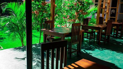 a group of wooden tables and chairs on a patio at Nguchiro Palace in Moshi